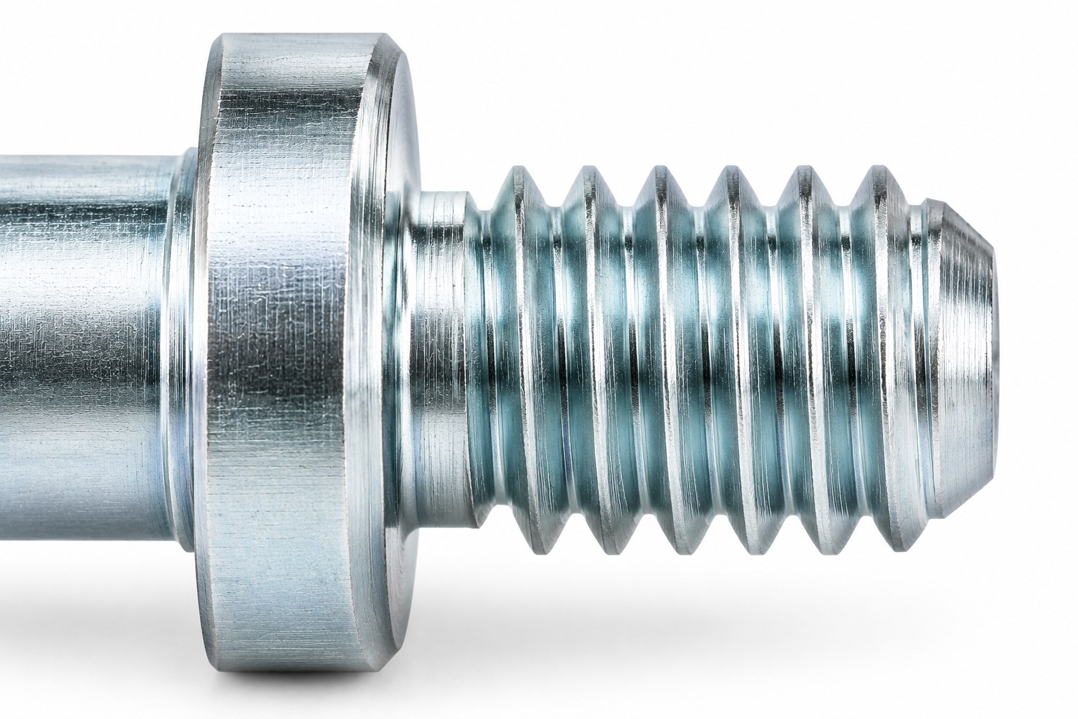 Macro of the short machine thread and blunt chamfered tip of a white zinc plated turned screw